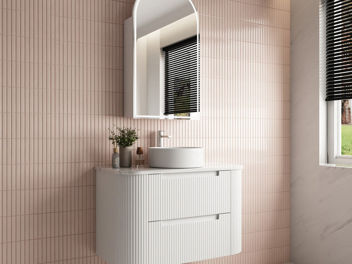 White fluted 900mm wall hung vanity with a round basin against pink tiles