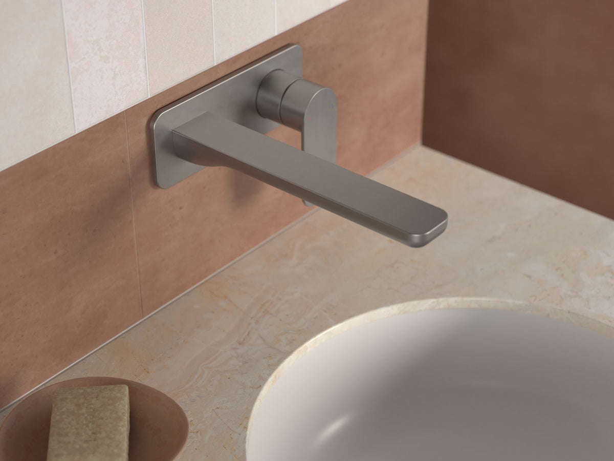 Brushed nickel wall mounted basin mixer above an inset basin on a stone benchtop