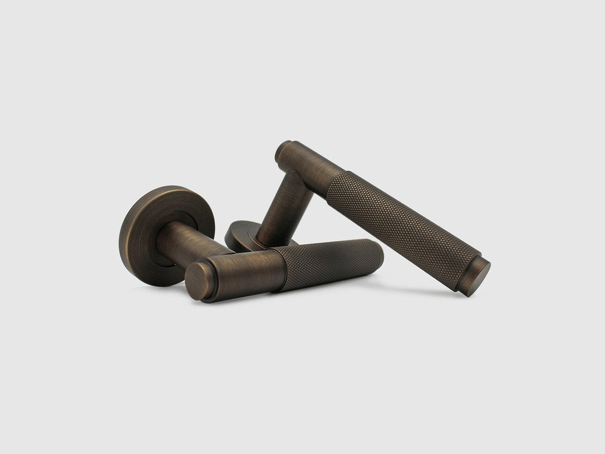 Zephra Knurled door handle levers in Aged Bronze