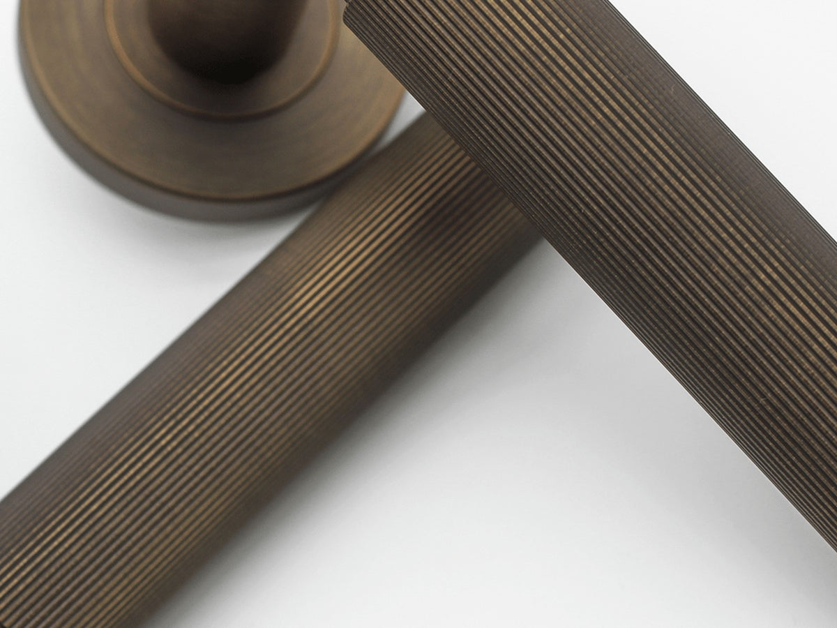 Zephra fluted solid steel hardware in an Aged Bronze PVD finish