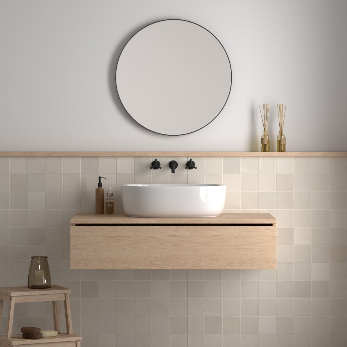 Off-white square tiles as a half-height bathroom wall below a round mirror