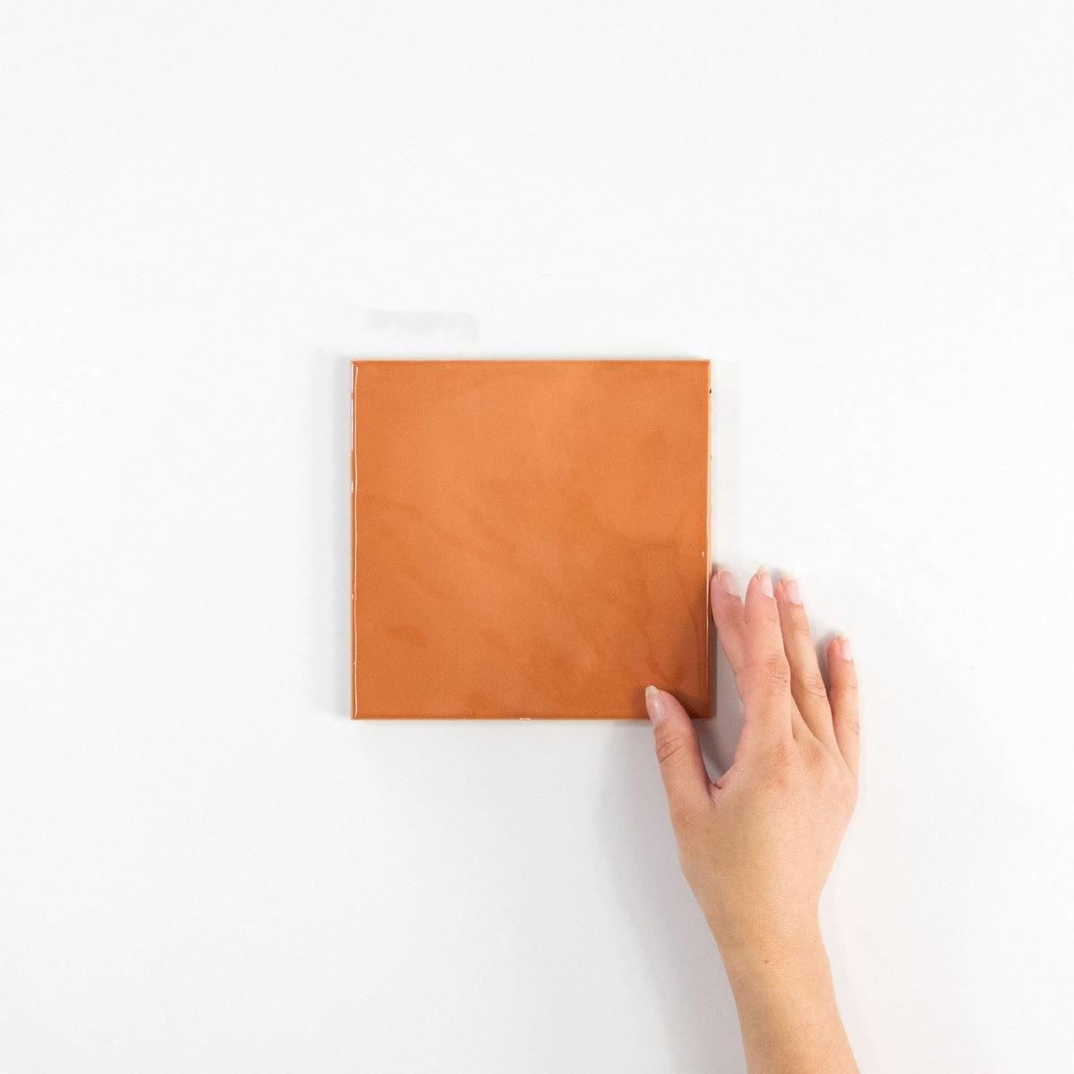 Gouache Mandarine ceramic wall tile, 155 x 155 in hand