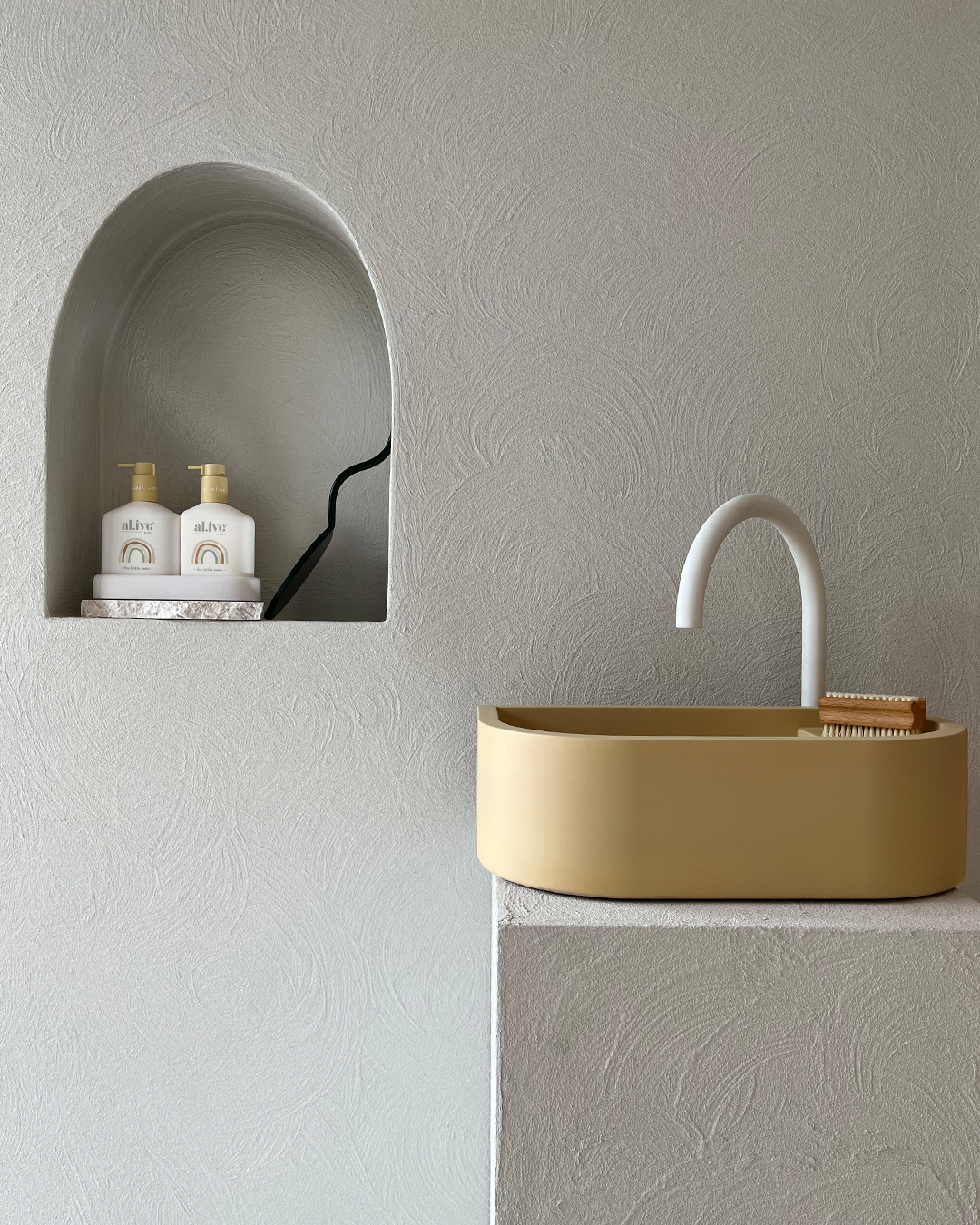 Nood Co Loop 01 Concrete Basin in Custard, installed in a finished bathroom