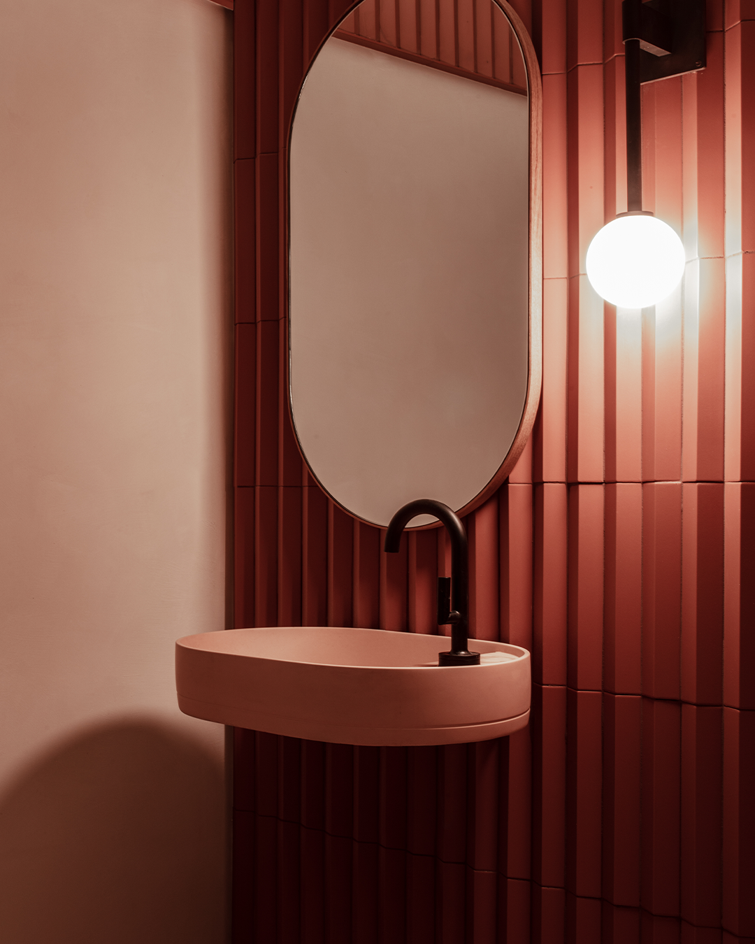 Nood Co Shelf Oval Concrete Basin in Blush Pink, installed in a finished bathroom