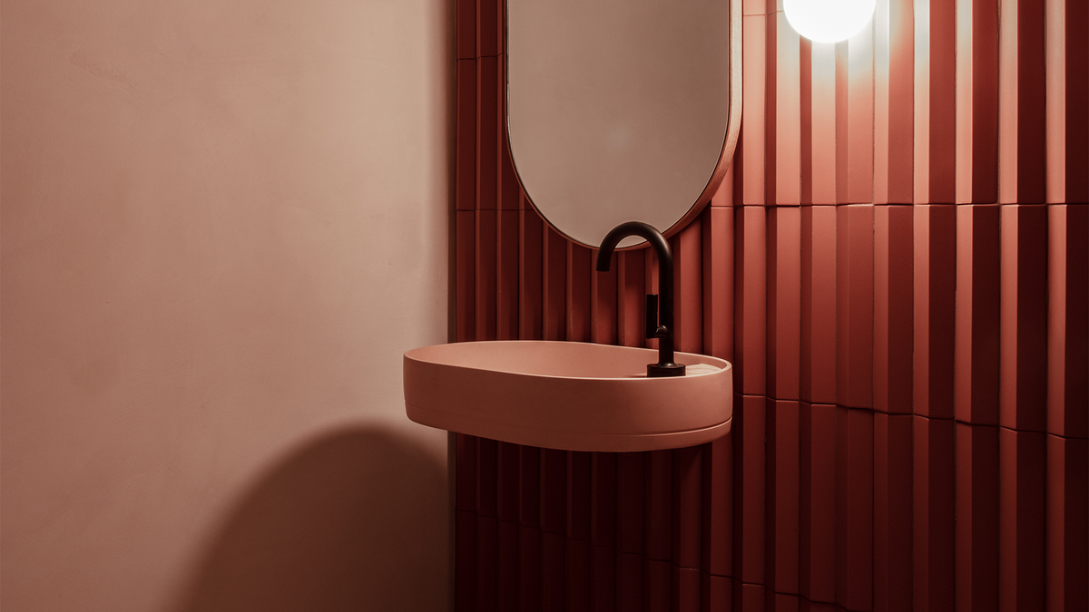 Nood Co Shelf Oval Concrete Basin in Blush Pink, installed in a finished bathroom