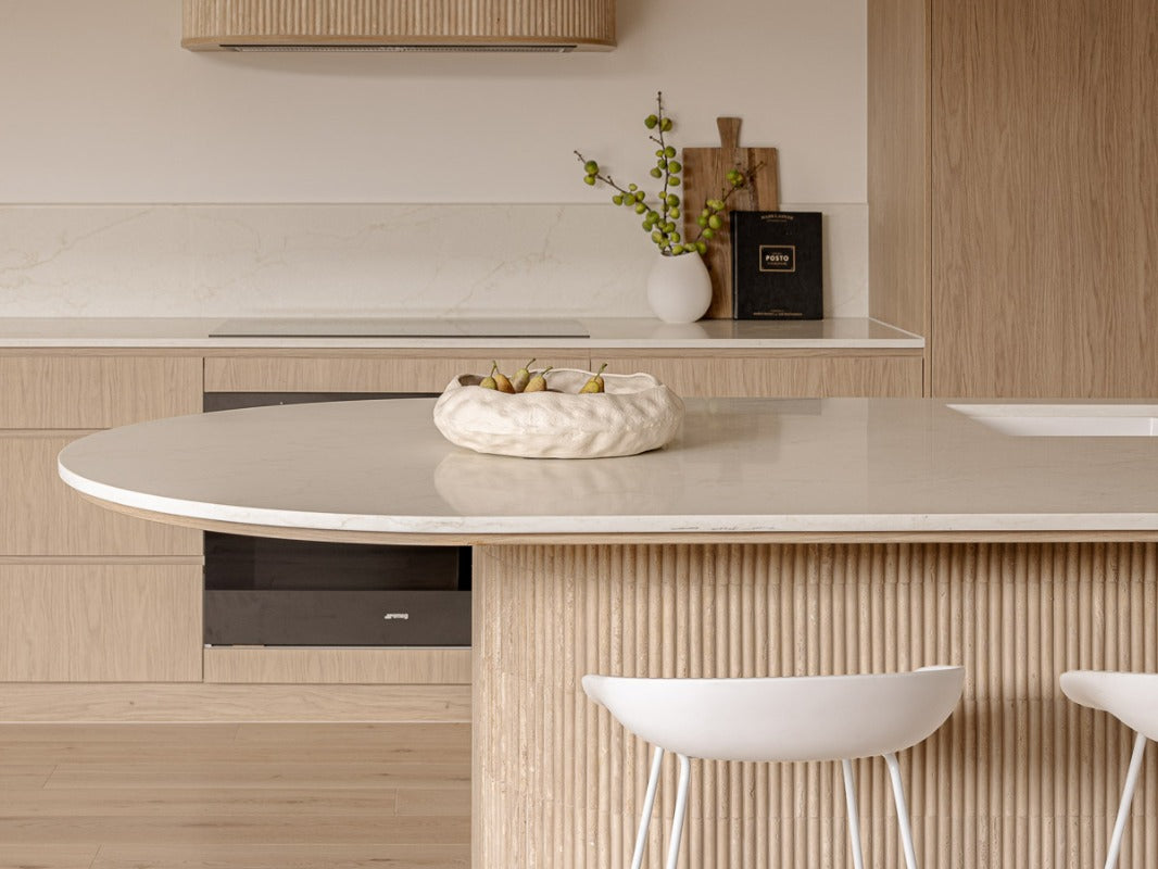 Tevel project kitchen with travertine-look benchtop and fluted timber island