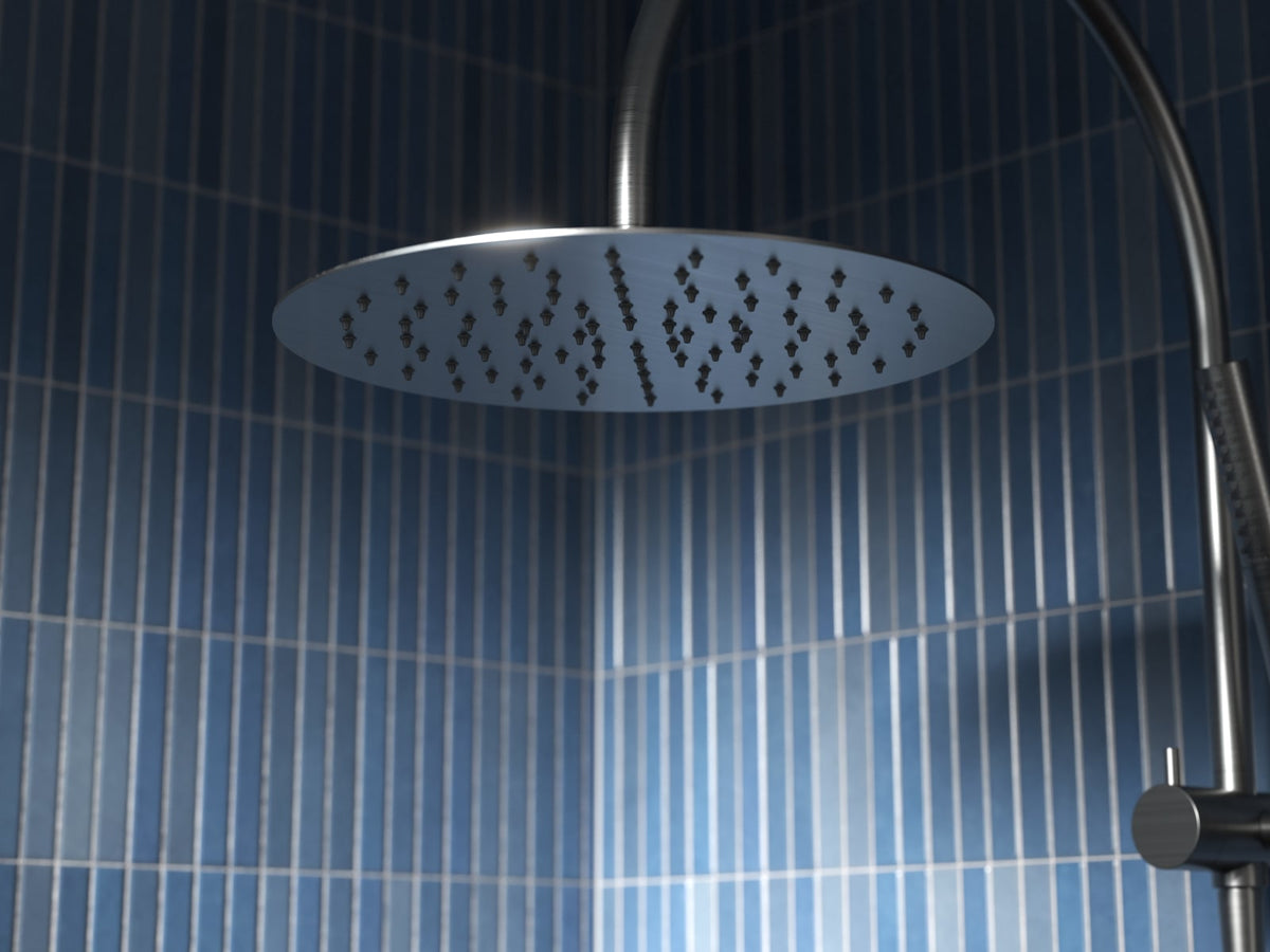 Chrome round shower rose on a gooseneck arm against blue tiles