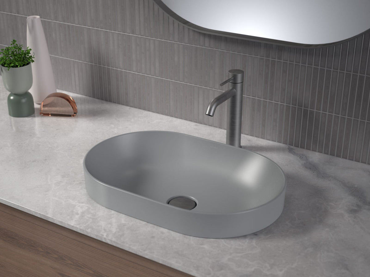 Gunmetal tall basin mixer on a stone benchtop with a matte grey basin