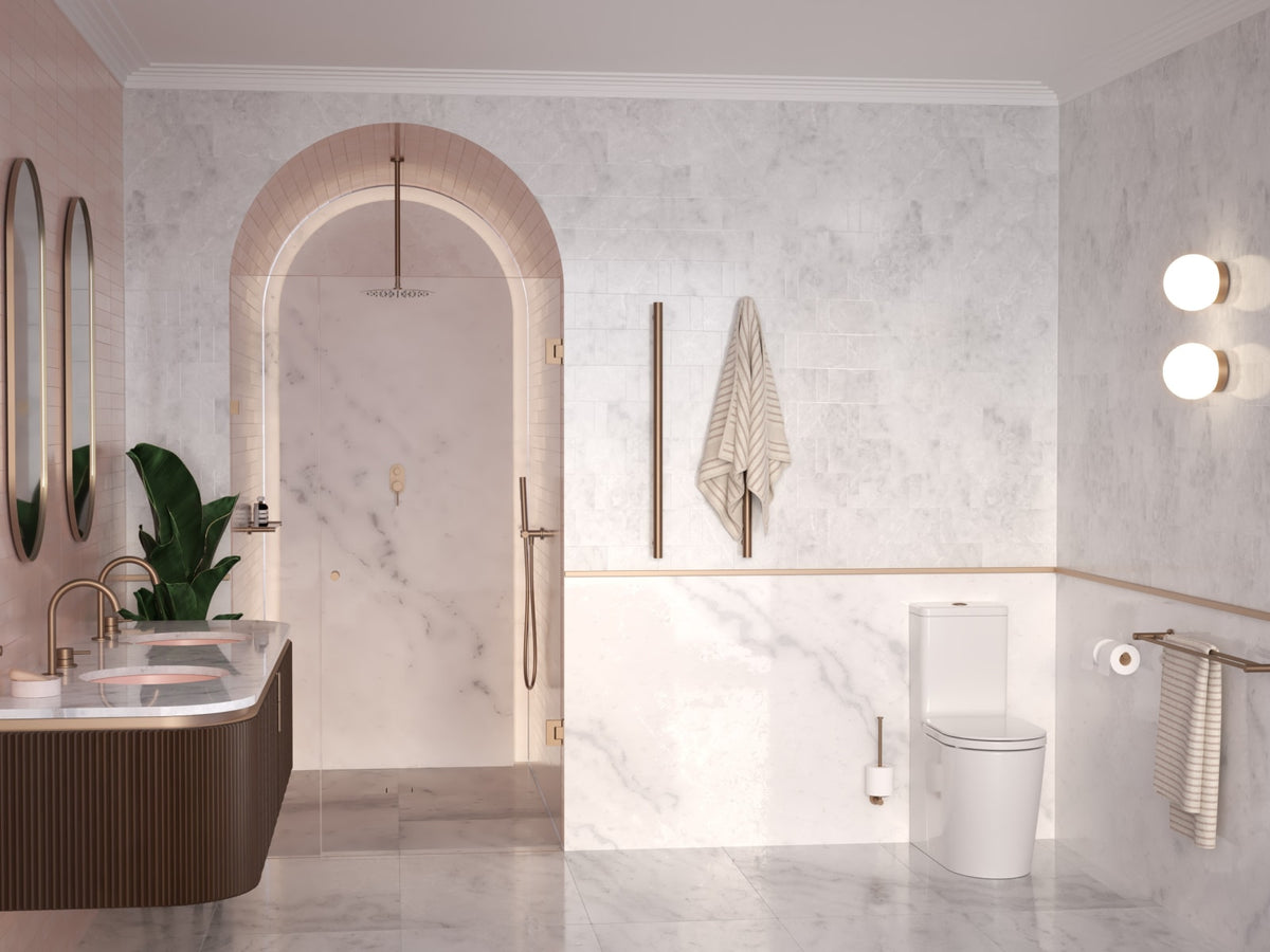 Marble bathroom with brushed brass towel rails and toilet roll holder