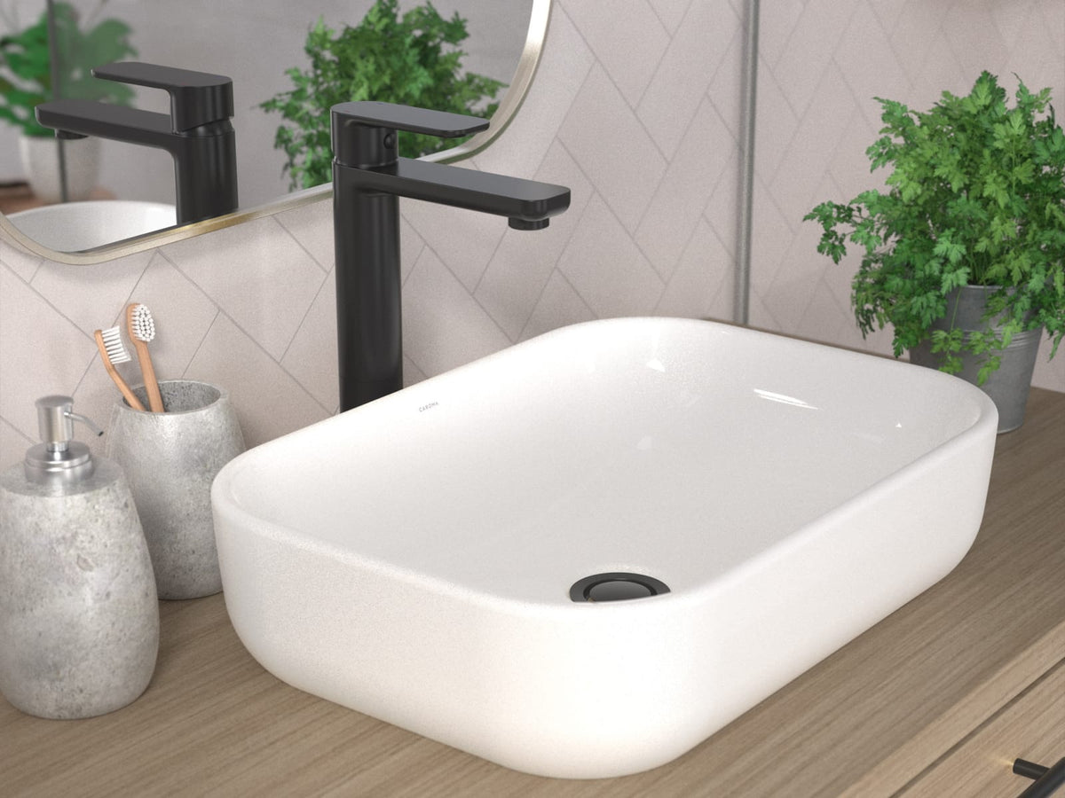 Above counter basin on a timber vanity with a matte black basin mixer