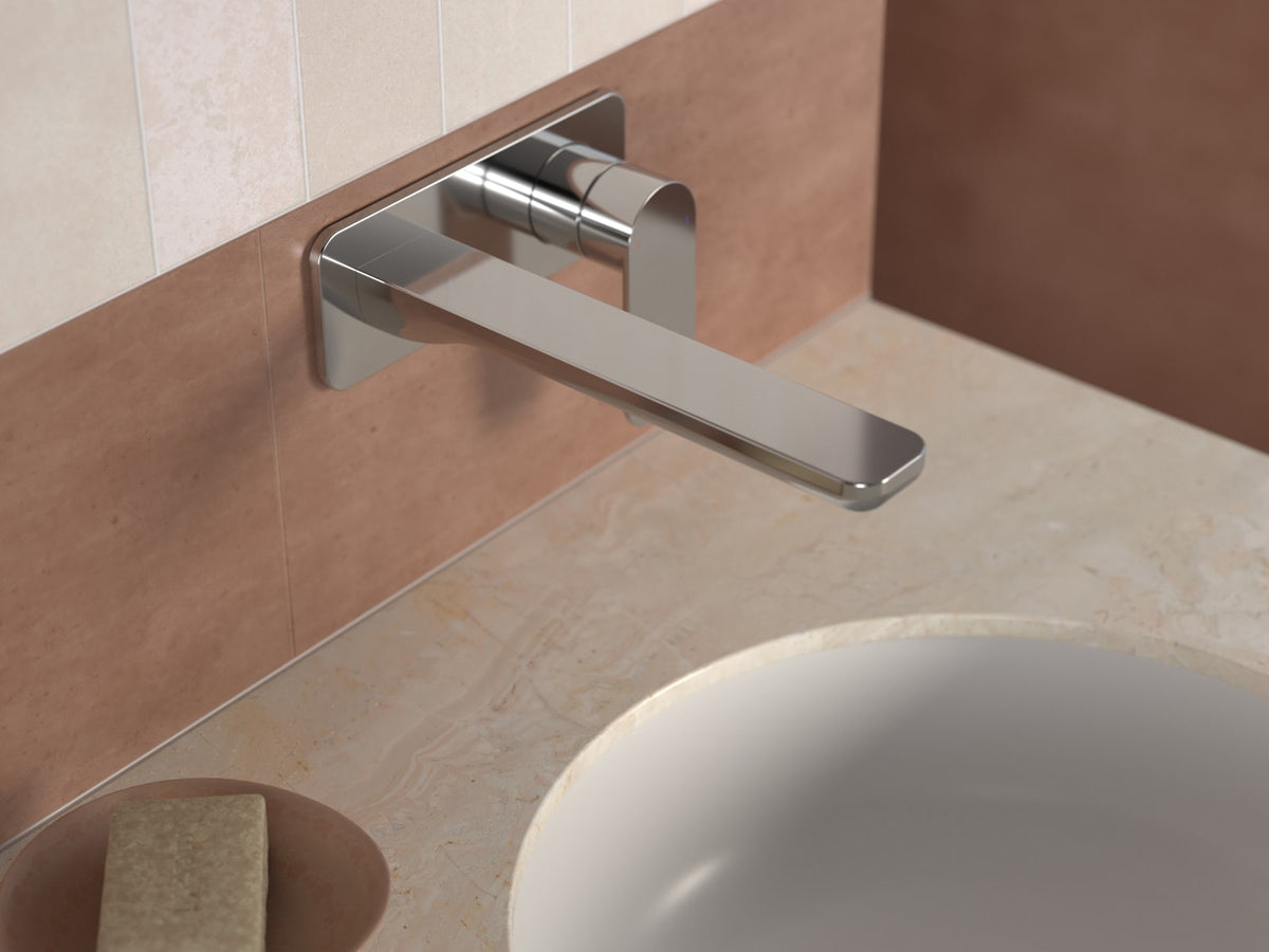 Chrome wall mounted basin mixer above an inset basin on a stone benchtop