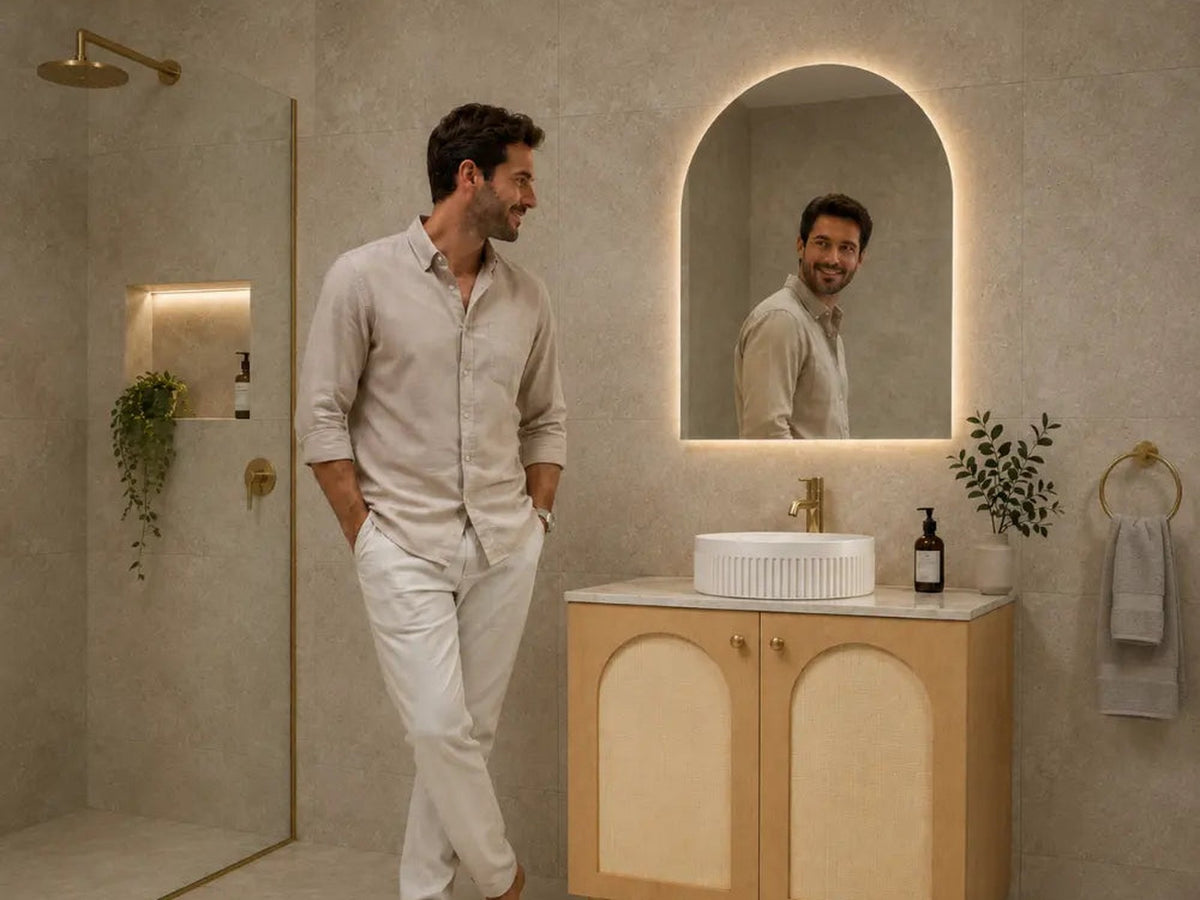 Timber floor standing vanity with arched backlit mirror in a stone bathroom