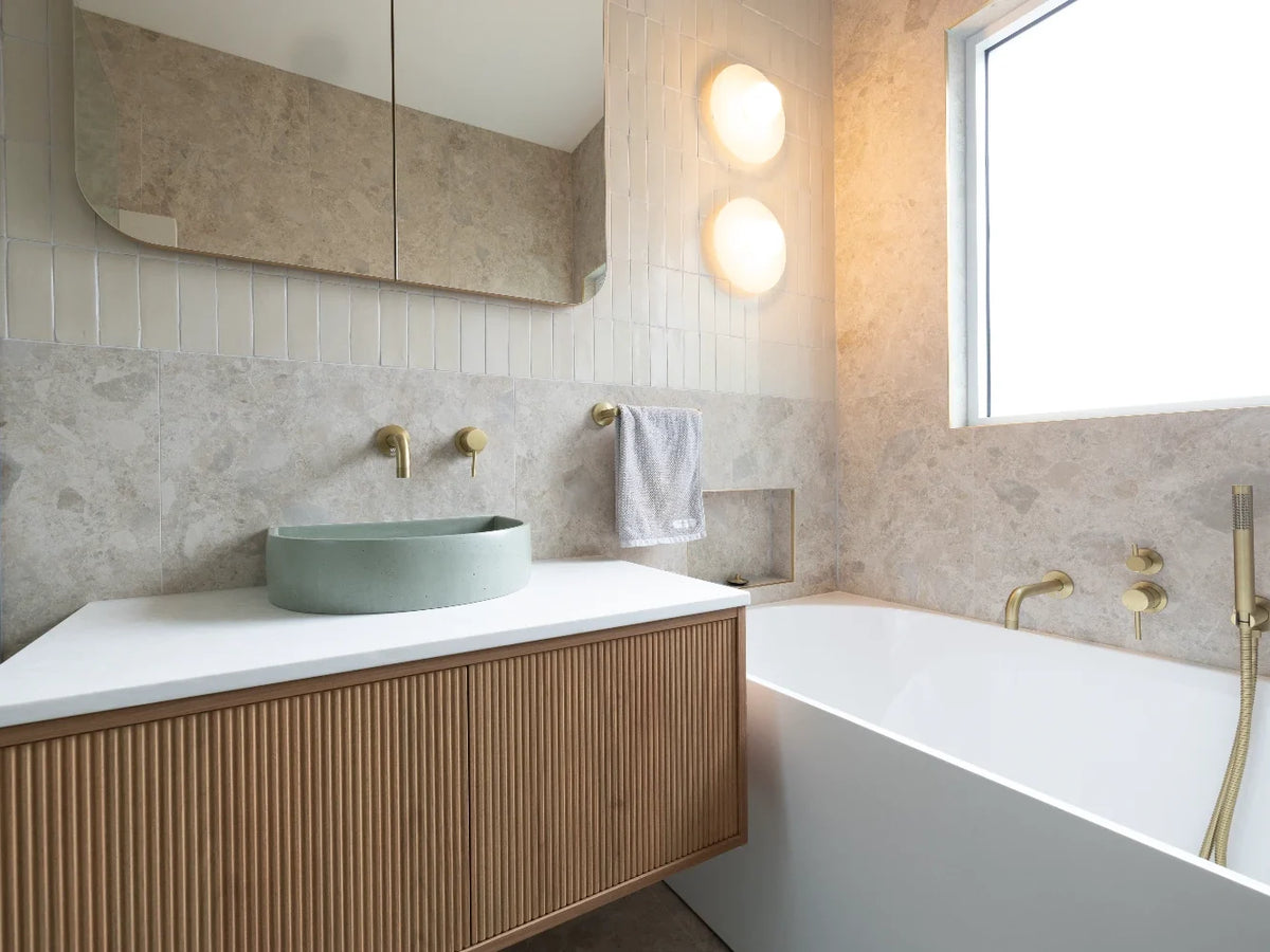 Calming Loftus bathroom with sage-green Botanica kit kat, warm white tiles and fluted timber vanity