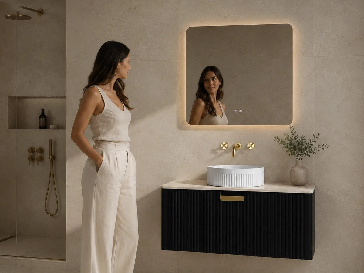 Black fluted wall hung vanity with stone top and backlit mirror