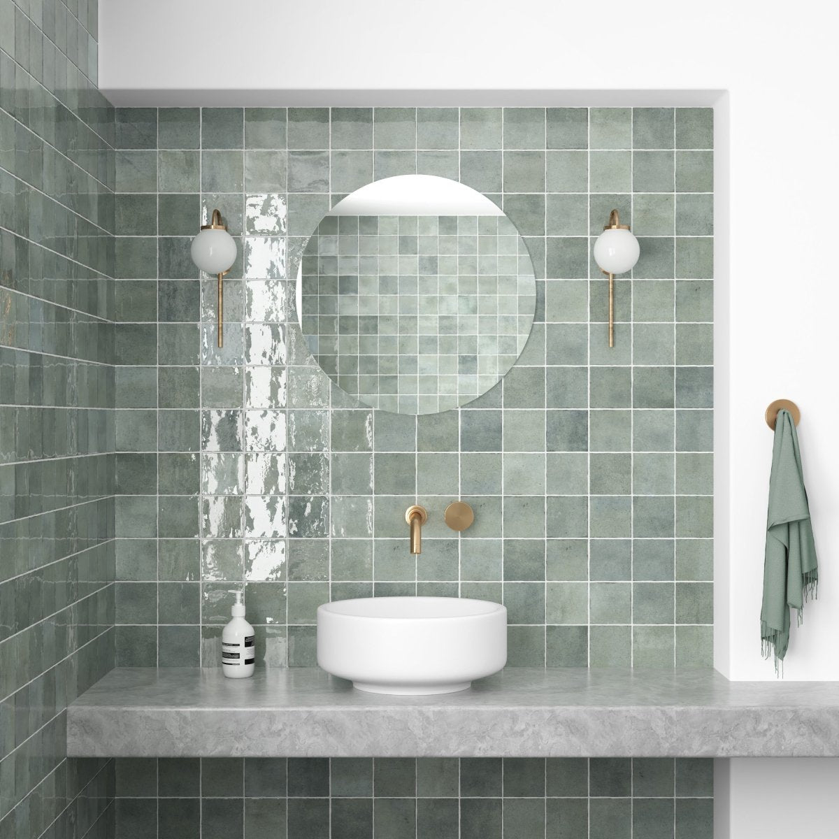 Mint gloss square wall tiles framing a round mirror above a concrete vanity