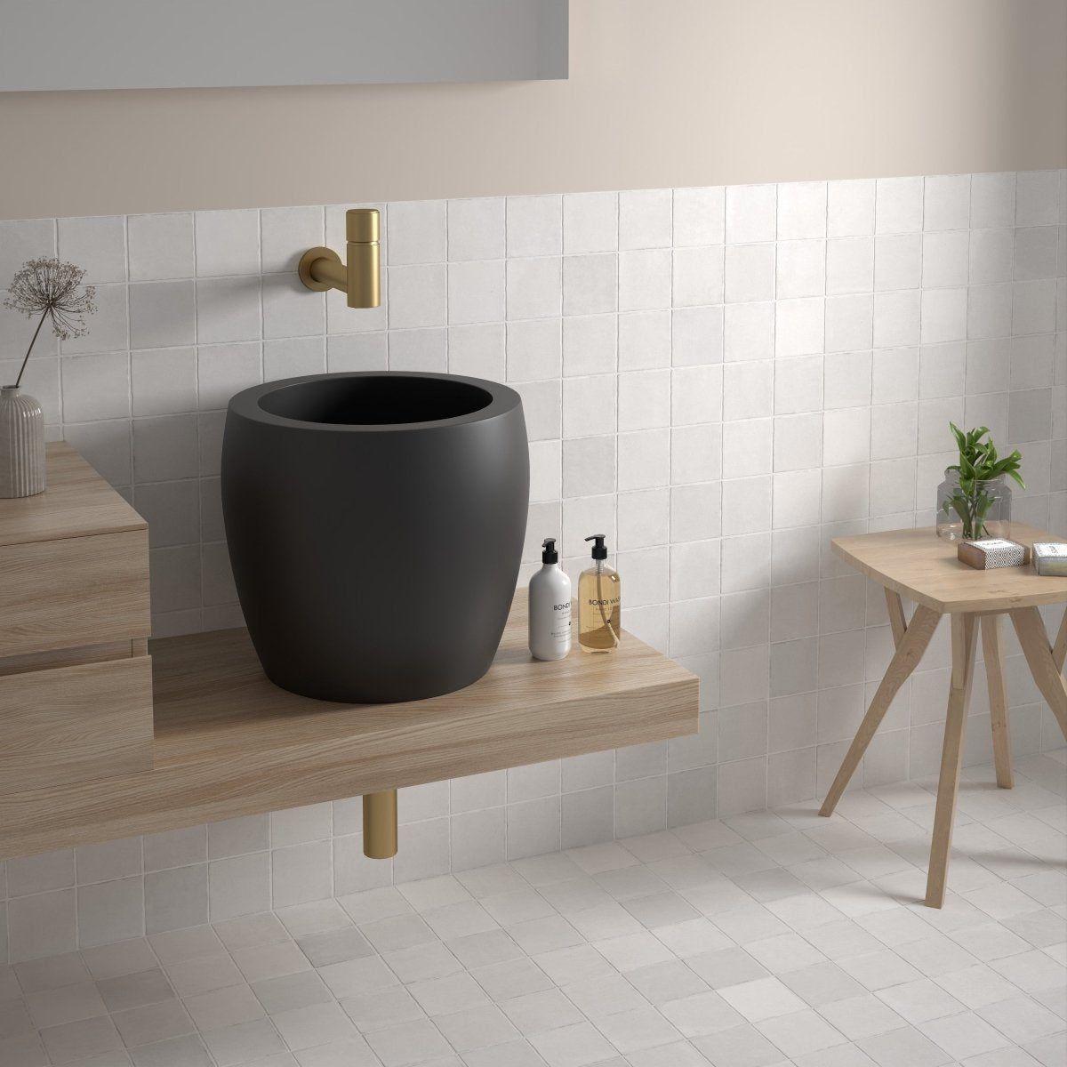White matt square tiles on bathroom walls and floor with a black vessel basin