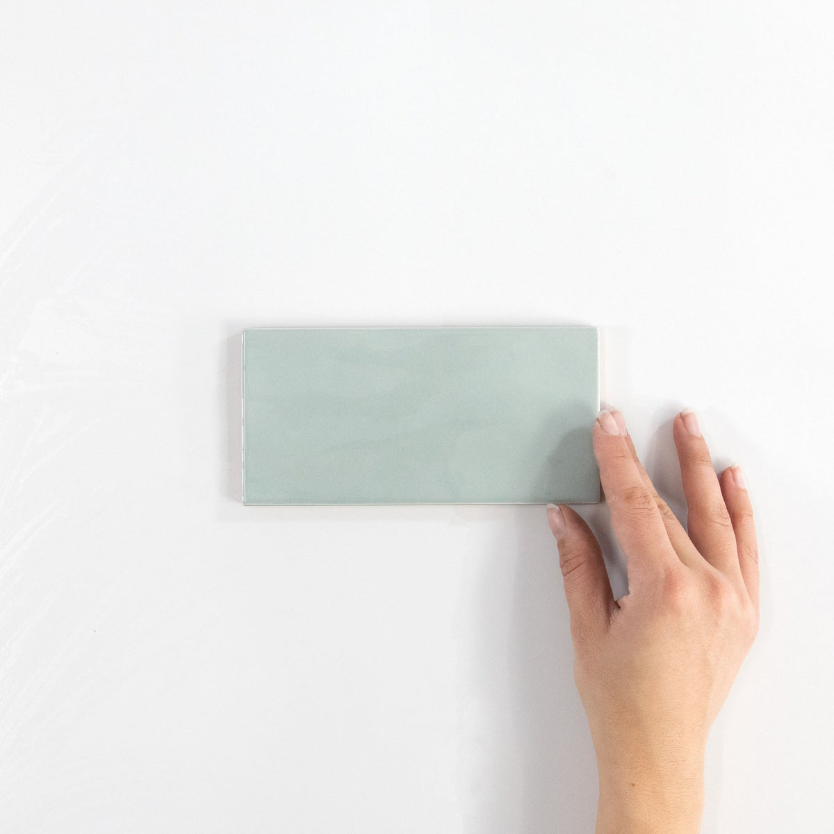 Gouache Ciel ceramic wall tile, 75 x 155 in hand