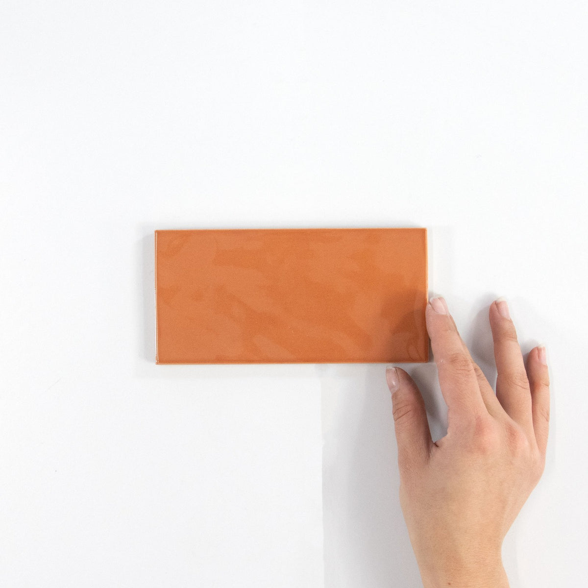 Gouache Mandarine ceramic wall tile, 75 x 155 in hand
