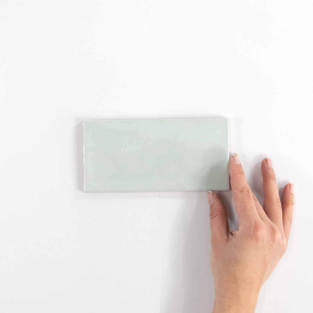 Gouache Mer ceramic wall tile, 75 x 155 in hand
