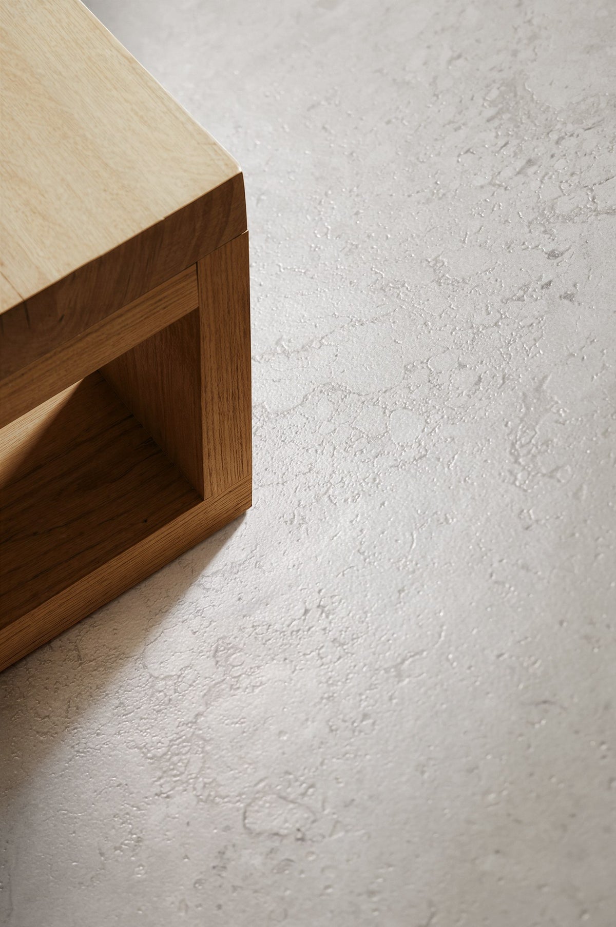 Luberon Cream limestone look porcelain floor beside an oak side table, showing the 3D Natural texture