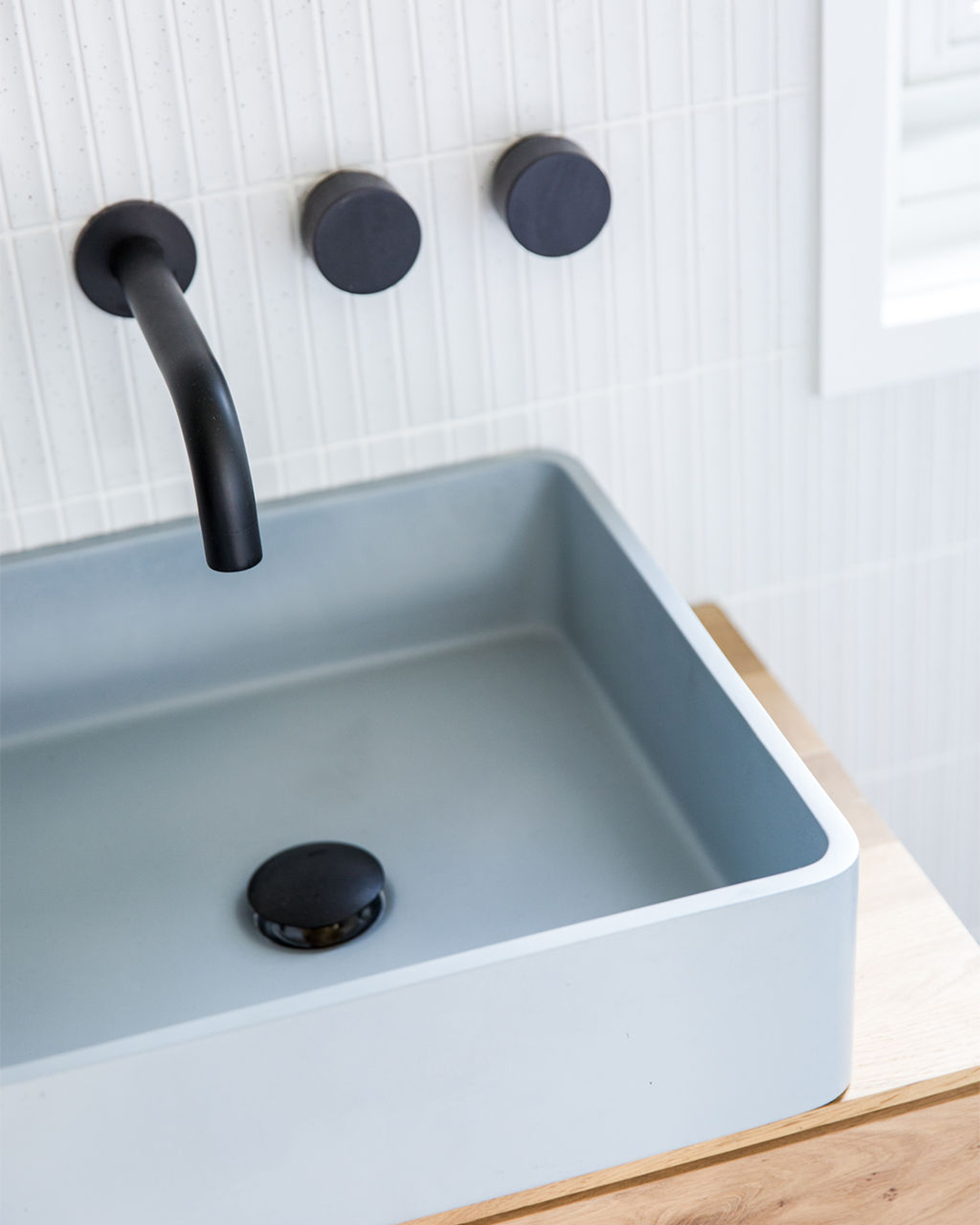 Nood Co Vesl Square Concrete Basin in Powder Blue, installed in a finished bathroom