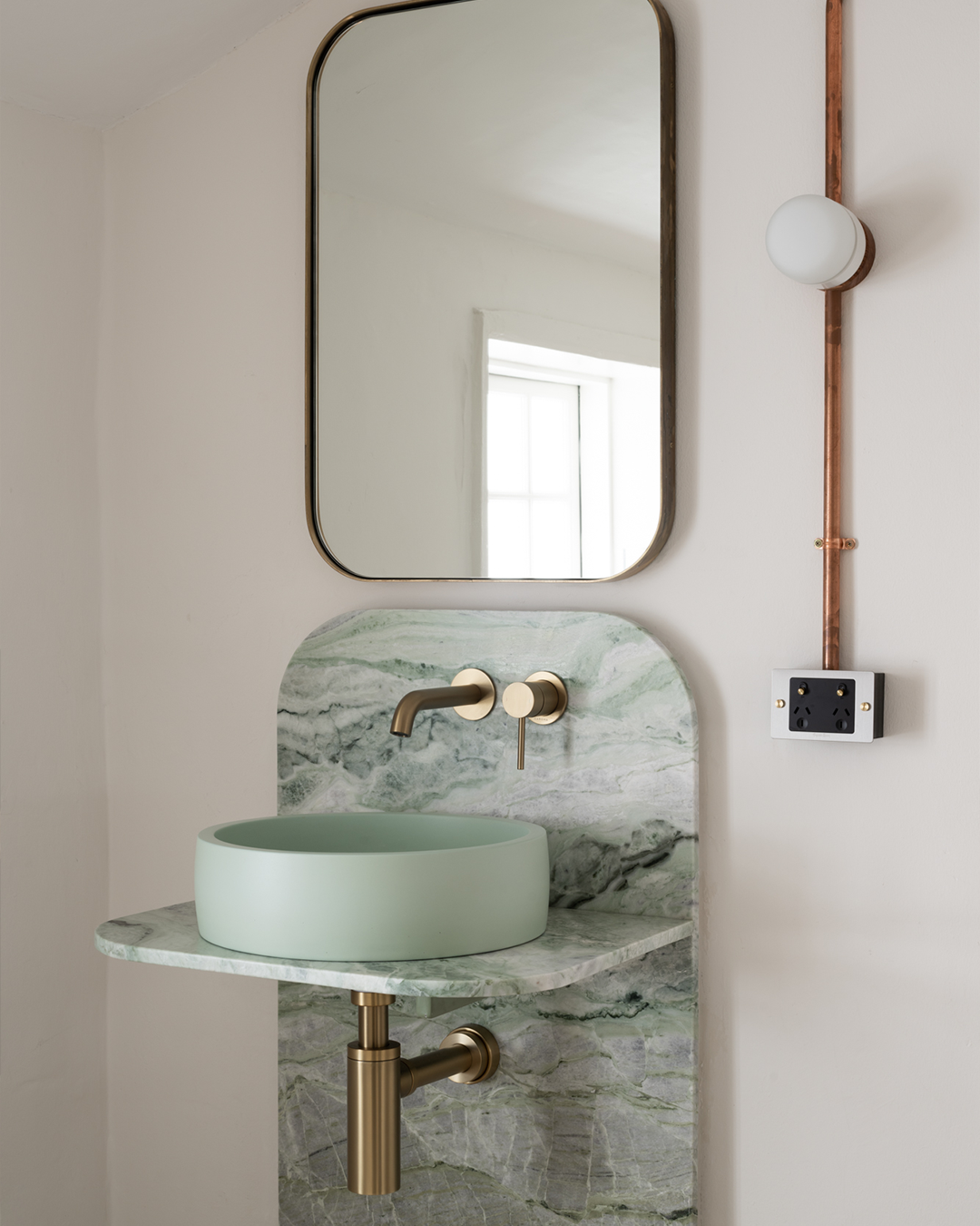 Nood Co Hoop Concrete Basin in Mint, installed in a finished bathroom