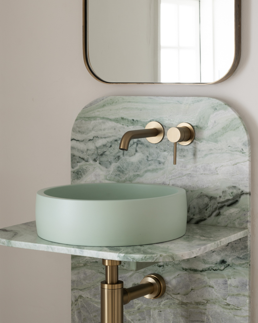 Nood Co Hoop Concrete Basin in Mint, installed in a finished bathroom